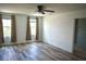 Primary bedroom featuring wood floors, ceiling fan, and two windows at 10019 Geese Trail Cir, Sun City Center, FL 33573