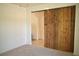 Bedroom featuring a decorative wooden sliding door at 10019 Geese Trail Cir, Sun City Center, FL 33573