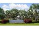 Cypress Creek community sign with palm trees, lush landscaping, and visible amenities at 10019 Geese Trail Cir, Sun City Center, FL 33573