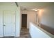 Upstairs hallway with wood-look floors and white walls at 10019 Geese Trail Cir, Sun City Center, FL 33573