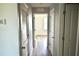 Hallway with wood-look floors and white doors at 10019 Geese Trail Cir, Sun City Center, FL 33573