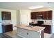 Kitchen with stainless steel appliances, ample cabinet space, and a center island sink at 10019 Geese Trail Cir, Sun City Center, FL 33573