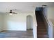 Living room featuring hardwood floors, a ceiling fan, and a staircase at 10019 Geese Trail Cir, Sun City Center, FL 33573