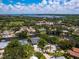 An aerial view of a neighborhood, showcasing waterfront properties and a picturesque landscape at 1031 Contento St, Sarasota, FL 34242