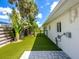 A green backyard alongside a white modern house at 1031 Contento St, Sarasota, FL 34242