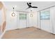 Airy bedroom featuring modern light fixtures, a ceiling fan, neutral paint, and light wood floors at 1031 Contento St, Sarasota, FL 34242