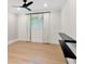 Clean bedroom with light floors, neutral paint, modern light fixture, and simple floating black shelves at 1031 Contento St, Sarasota, FL 34242
