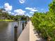 A picturesque dock running along the waterfront with lush landscaping and azure skies at 1031 Contento St, Sarasota, FL 34242