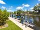 Dock with boat lift situated on the water with lush landscaping at 1031 Contento St, Sarasota, FL 34242