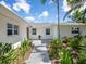 Elegant entrance featuring a patterned tile walkway and mature landscaping at 1031 Contento St, Sarasota, FL 34242