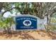 The Out-of-Door Academy entrance sign is framed by lush trees and palm trees at 1031 Contento St, Sarasota, FL 34242