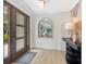 Inviting entryway with a wooden front door, modern decor, and light hardwood floors at 1031 Contento St, Sarasota, FL 34242