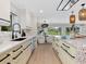Bright kitchen with stone countertops and stainless steel appliances leads to dining area at 1031 Contento St, Sarasota, FL 34242