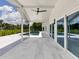 Outdoor patio with a partial view of the blue in-ground pool, lush green trees and bright blue skies at 1031 Contento St, Sarasota, FL 34242