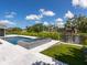 An elegant backyard pool with an attached spa sits next to a canal with boat dockage at 1031 Contento St, Sarasota, FL 34242
