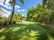 A backyard putting green is surrounded by lush tropical landscaping, perfect for recreation at 1031 Contento St, Sarasota, FL 34242