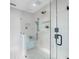 Contemporary glass walk-in shower featuring mosaic floors, a built-in bench, and neutral accent tiles at 1031 Contento St, Sarasota, FL 34242