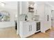 Stylish wet bar featuring custom cabinetry, wine fridge, and modern fixtures at 1031 Contento St, Sarasota, FL 34242