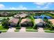 Aerial view of home featuring mature trees and lush landscaping in a serene neighborhood with a tranquil lake at 11221 Sandhill Preserve Dr, Sarasota, FL 34238