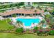 Aerial view showcasing a resort-style pool, expansive clubhouse, and lush tropical landscaping at 11221 Sandhill Preserve Dr, Sarasota, FL 34238