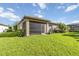 Green backyard with a screened lanai attached to the back of the house at 11221 Sandhill Preserve Dr, Sarasota, FL 34238