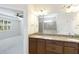 Elegant bathroom boasts a double vanity with granite countertop and a glass enclosed shower at 11221 Sandhill Preserve Dr, Sarasota, FL 34238
