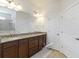 Well lit bathroom featuring double vanity, granite countertop, and tile shower with seamless glass door at 11221 Sandhill Preserve Dr, Sarasota, FL 34238