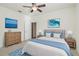 Primary bedroom boasts serene decor, ocean artwork, and plush blue accents for relaxation at 11221 Sandhill Preserve Dr, Sarasota, FL 34238