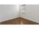 Vacant room features hardwood floors, white walls, a single window, and baseboard trim at 11221 Sandhill Preserve Dr, Sarasota, FL 34238