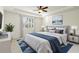 Serene bedroom features a tray ceiling, modern decor and ample natural light from the window at 11221 Sandhill Preserve Dr, Sarasota, FL 34238