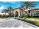 View of the clubhouse entrance with an attractive circular driveway and manicured landscaping at 11221 Sandhill Preserve Dr, Sarasota, FL 34238