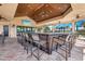 Stylish community bar area with large screen TV, ceiling fans, bar seating, and scenic outdoor views at 11221 Sandhill Preserve Dr, Sarasota, FL 34238