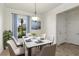 Cozy dining room with stylish decor, a marble table set for six, and a window for natural light at 11221 Sandhill Preserve Dr, Sarasota, FL 34238