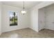 Unfurnished dining room with tile floors, a window for natural light, and crown molding at 11221 Sandhill Preserve Dr, Sarasota, FL 34238