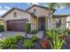 Inviting single-Gathering home featuring a well-manicured lawn and a charming exterior with a two-car garage at 11221 Sandhill Preserve Dr, Sarasota, FL 34238