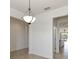 Bright hallway featuring tile flooring, modern lighting fixture, and white walls at 11221 Sandhill Preserve Dr, Sarasota, FL 34238