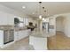 Bright kitchen with a large island, stainless steel appliances, and white cabinetry providing ample storage space at 11221 Sandhill Preserve Dr, Sarasota, FL 34238