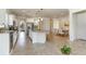 Bright kitchen featuring an island with seating and stainless steel appliances open to the dining room at 11221 Sandhill Preserve Dr, Sarasota, FL 34238