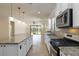 Open-concept kitchen with stainless steel appliances, granite countertops, and tile backsplash for a modern feel at 11221 Sandhill Preserve Dr, Sarasota, FL 34238