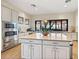 Gourmet kitchen with large island, custom cabinets, stainless steel appliances, and a picture window at 11221 Sandhill Preserve Dr, Sarasota, FL 34238