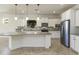 Modern kitchen boasts granite countertops, stainless steel appliances, and custom white cabinetry at 11221 Sandhill Preserve Dr, Sarasota, FL 34238