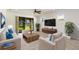 Cozy living room with modern furniture, neutral tones, and sliding glass doors, with lots of natural light at 11221 Sandhill Preserve Dr, Sarasota, FL 34238