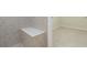 Bright shower features a built-in shower bench, sleek tile surround and door to room with carpet flooring at 11221 Sandhill Preserve Dr, Sarasota, FL 34238