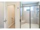 Bathroom featuring tiled walk-in shower with bench and glass door, plus adjacent toilet and vanity at 12398 Keyridge Loop, Largo, FL 33778