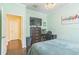 Comfortable bedroom featuring hardwood floors, a chandelier, a desk, and a dresser with TV at 12398 Keyridge Loop, Largo, FL 33778