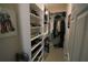 Walk-in closet showcasing shelving and clothes racks for organized storage at 12398 Keyridge Loop, Largo, FL 33778