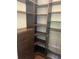 Custom closet featuring built in shelving, drawers, and chrome storage racks at 12398 Keyridge Loop, Largo, FL 33778