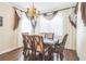 Elegant dining room with hardwood floors, large window, and decorative chandelier at 12398 Keyridge Loop, Largo, FL 33778