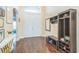 Welcoming foyer featuring wood floors, high ceilings, and convenient storage and seating at 12398 Keyridge Loop, Largo, FL 33778