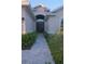 Inviting front entrance with lush landscaping, stone walkway, and elegant double doors at 12398 Keyridge Loop, Largo, FL 33778